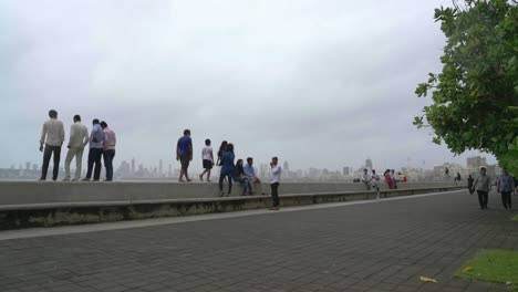 People-Standing-On-The-Embankment-Of-Back-Bay-Along-The-Marine-Drive-During-The-Global-Pandemic-Coronavirus-In-Mumbai,-India