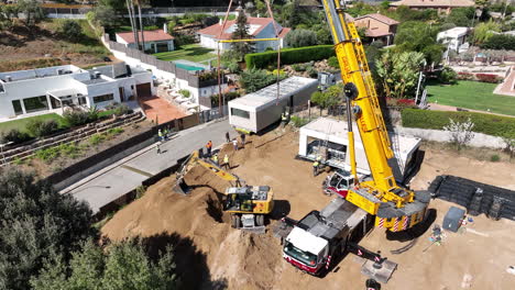 Aerial-view-over-trailer-delivering-modular-home-property-to-sunny-building-site-plot