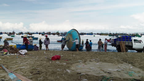 Traditional-basket-boats-rolled-into-sea-by-Mui-Ne-fishermen-for-fishing