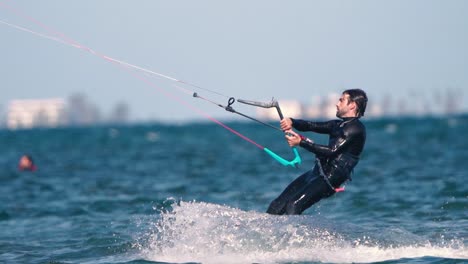 Los-Alcazares,-Spain,-May-3,-2023:-Sportsman-practicing-kite-surf-sport-at-the-beach-on-a-windy-day-at-the-Spanish-coasts