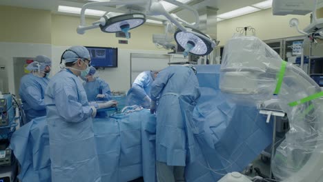 Surgeons-perform-surgery-on-patient-with-surgical-team