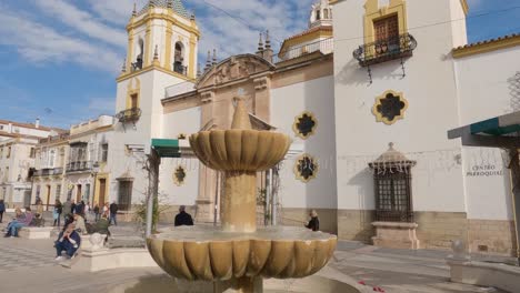 View-of-the-fountain-and-the-church-Parroquia-de-Nuestra-Señora-del-Socorro-in-Ronda,-Spain
