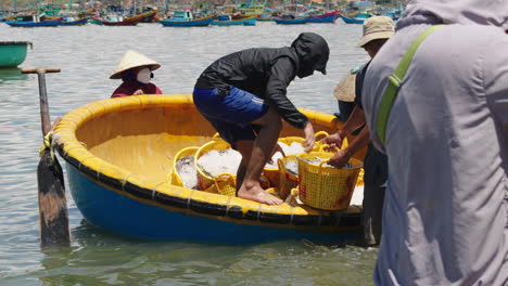 Baskets-with-fresh-catch-are-offloaded-from-basket-boats-by-Mui-Ne-fishermen