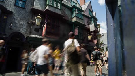 timelapse-of-one-of-the-streets-of-the-harry-potter-theme-park-at-universal-studios,-orlando-florida,-USA,-panning-camera-movement-as-tourists-walk-down-the-street