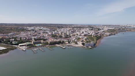 Approaching-aerial-view-of-Estombar,-Portugal,-on-the-Arade-River