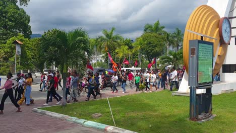 People-marching-with-flags-during-political-party-campaign-in-the-capital-Dili,-Timor-Leste-for-upcoming-election-2023