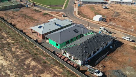 Yarrawonga,-Victoria,-Australia---18-April-2023:-Aerial-view-of-tilers-working-on-the-roof-of-a-newly-built-house-at-Silverwoods-in-Yarrawonga