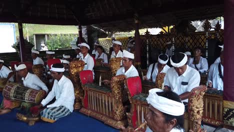 Gamelan-Orchestra-Plays-Music-in-Balinese-Hindu-Ceremony-in-Samuan-Tiga-Temple,-Musicians-with-Mallets-and-Percussive-Instruments