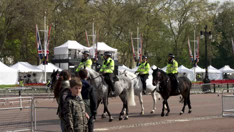 Met-Police-On-Horseback-Riding-Past-Tourists-And-Broadcast-Tents-Outside-Buckingham-Palace-In-Preparation-For-King-Charles-Coronation-Ceremony