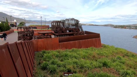 Hobart,-Tasmania,-Australia---13-March-2019:-Mona-Museum-outdoor-exhibit-of-a-rusted-metal-sculpture-of-two-trucks-on-the-Derwent-River-in-Hobart-Tasmania