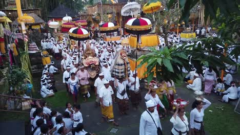 Aerial-View-Above-Balinese-Hindu-People-Walking-Procession-with-Barong-Mystical-Creatures-in-Temple-Ceremony,-Bali-Indonesia
