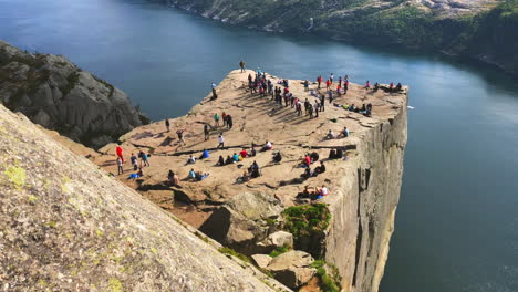 Crowded-cliff-edge-of-Preikestolen-Pulpit-Rock-next-to-the-lake-waters-in-Rogaland-county-Norway