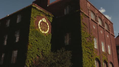 Old-red-brick-building-with-ivy-growing-on-the-wall