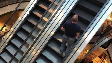 Calm-shopper-on-a-moving-escalator-of-a-indoor-shopping-mall-in-Stockholm-Sweden