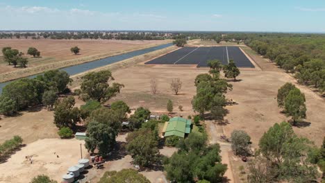 Mulwala,-New-South-Wales,-Australia---18-February-2023:-New-ESCO-Pacific-solar-farm-outside-Mulwala-with-older-style-farm-and-buildings-in-the-foreground