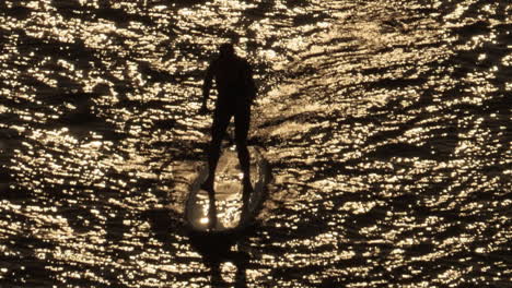 A-Man-On-A-Paddle-board-With-beautiful-sunset-reflecting-in-the-sea-of-Stockholm