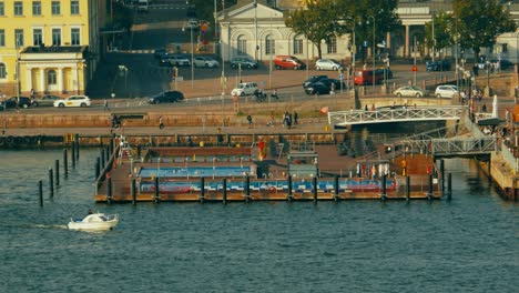 Tracking-aerial-shot-of-a-small-leisure-boat-in-the-harbor-of-Helsinki