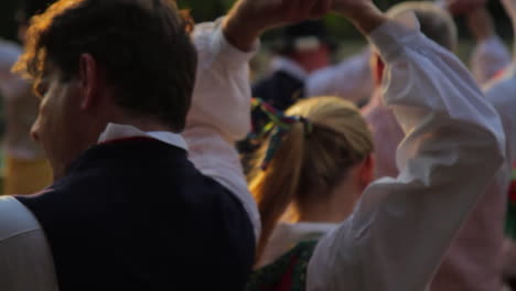 Beautiful-and-graceful-Swedish-folk-dancing-presented-live-on-stage-in-the-tradition-of-celebrating-Midsummer-as-musicians-play-the-violin