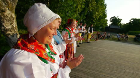Beautiful-and-graceful-Swedish-folk-dancing-presented-live-on-stage-in-the-tradition-of-celebrating-Midsummer-as-musicians-play-the-violin