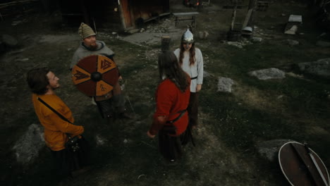 Vikings-socializing-and-practicing-their-sword-skills-with-each-other-in-a-clam-and-charming-little-village-in-a-viking-age-village-reenactment-in-Sweden