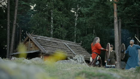 Vikings-socializing-and-practicing-their-sword-skills-with-each-other-in-a-clam-and-charming-little-village-in-a-viking-age-village-reenactment-in-Sweden