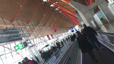 Dutch-angle-shot-of-people-walking-on-an-autowalk-in-Madrid-airport