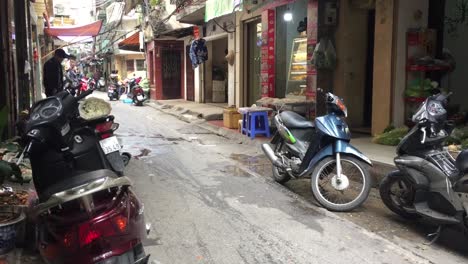Man-on-a-bike-in-lonely-alleyway-in-Hanoi,-Vietnam