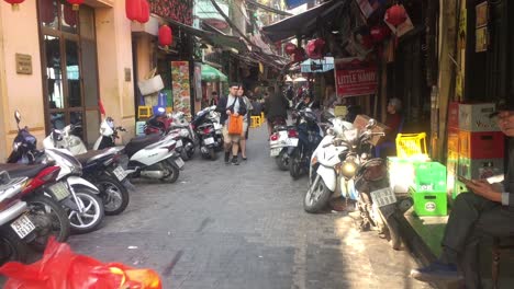 Tight-alleyway-with-scooters-in-Hanoi,-Vietnam