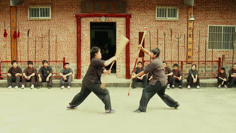 Martial-Arts-Kung-Fu-Fighters-practicing-in-Sham-Fight,-Tracking-Shot