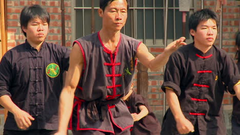 Group-of-asian-people-praciting-martial-arts-with-the-same-movements
