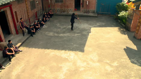 Martial-Arts-Kung-Fu-Master-Solo-Fighting-with-Spear-on-School-Yard