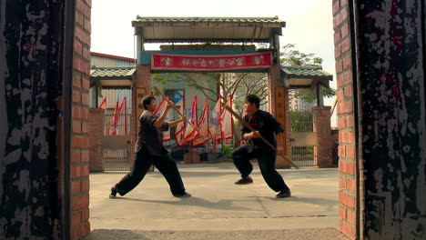 Duo-martial-arts-students-learning-to-stick-fight-on-a-rookie-level