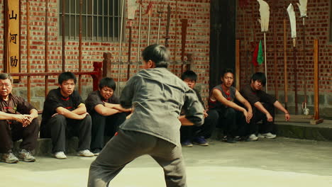 Skilled-Oriental-Fighter-demonstrating-Kung-Fu-at-Martial-Arts-School-Tracking-Shot