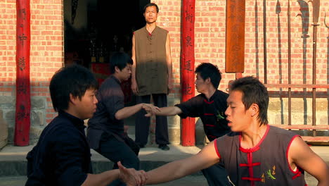 Master-of-ancient-Chinese-martial-arts-guides-hand-movements-of-boys