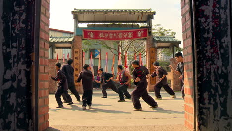 Group-of-young-boys-while-training-ancient-Chinese-martial-arts-in-courtyard