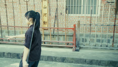 Young-Asian-Girl-training-with-Oriental-Martial-Arts-Sword