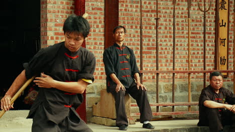 Asian-Martial-Arts-Fighter-training-with-Kung-Fu-Staff-Weapon-Tracking
