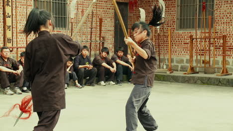 Young-Asian-Girls-in-Martial-Arts-Sham-Fight-Duel-with-Spear-and-Staff