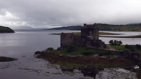 Eilean-Donan-Castle-drone-shot-at-sunset-on-cloudy-moody-day