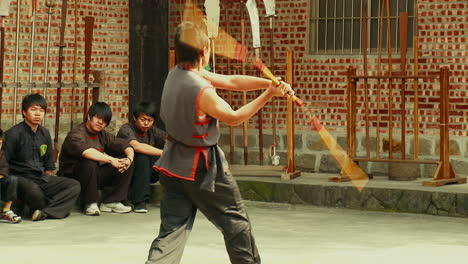 Taiwanese-nunchaku's-master-doing-fast-movements-in-a-martial-arts-gym