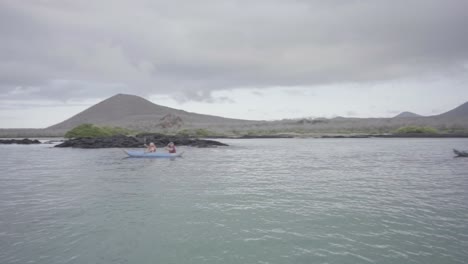 3-kayaks-with-tourists-are-kayaking-on-the-ocean-of-the-Galapagos-islands