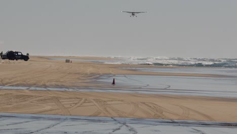 Tourist-plane-landing-on-beach