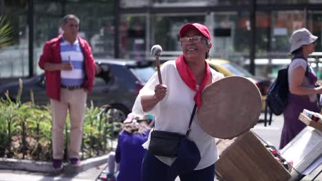 A-woman-is-playing-a-drum-during-a-rally-for-International-Women's-day-on-the-streets-of-Quito