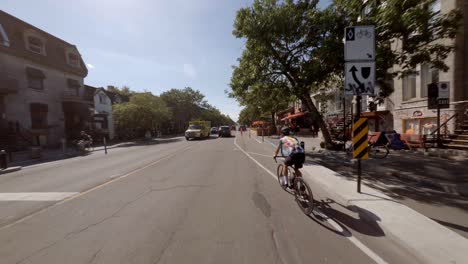 POV-Cycling-Along-Berri-Street-Onto-Bike-Lane-In-Montreal,-Canada