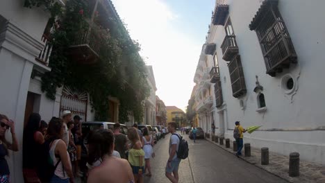 A-tour-guide-holding-a-yellow-umbrella-is-guiding-a-group-of-tourists-through-the-streets-of-Cartagena-de-Indias,-Colombia