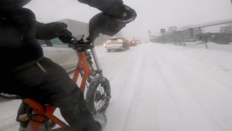 Side-Angle-POV-Of-Courier-On-Radburro-Travelling-During-Heavy-Snow-Alongside-Traffic-In-Montreal