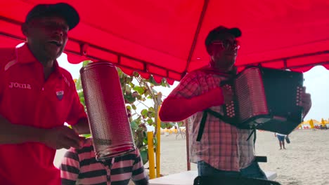 A-man-plays-the-accordion-while-another-sings-and-plays-the-Guacharaca