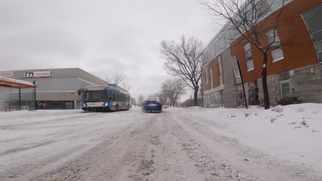 Low-Angle-POV-Driving-Along-Icy-Snow-Covered-Road-In-Ville-Marie-Neighbourhood-In-Montreal