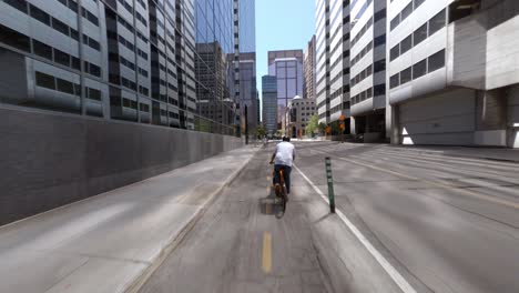 POV-Following-Bike-Delivery-Courier-Along-Empty-De-Maisonneuve-Boulevard-In-Montreal