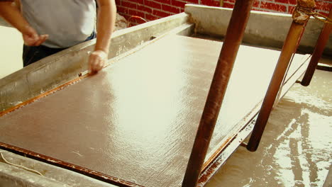 Man-Opening-Wooden-Frame-of-Paper-Making-Screen,-Traditional-Chinese-Paper-Mill
